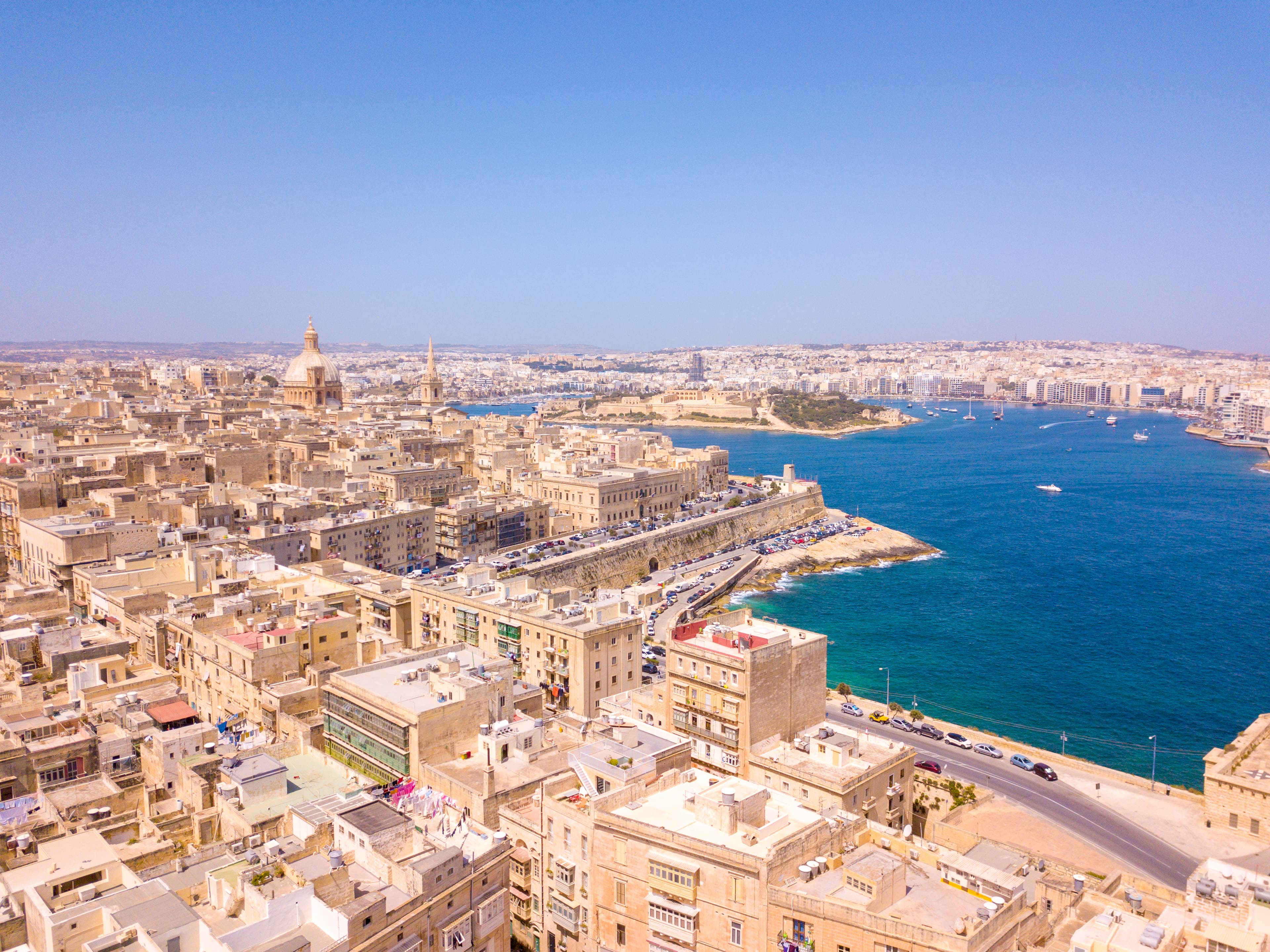 Aerial view of old town buildings near water, Valletta, Malta